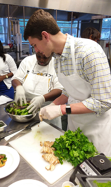 University of South Alabama (USA) medical student helping with food preparation